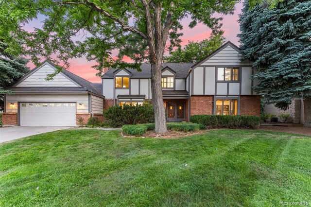 view of front of home featuring a garage and a lawn