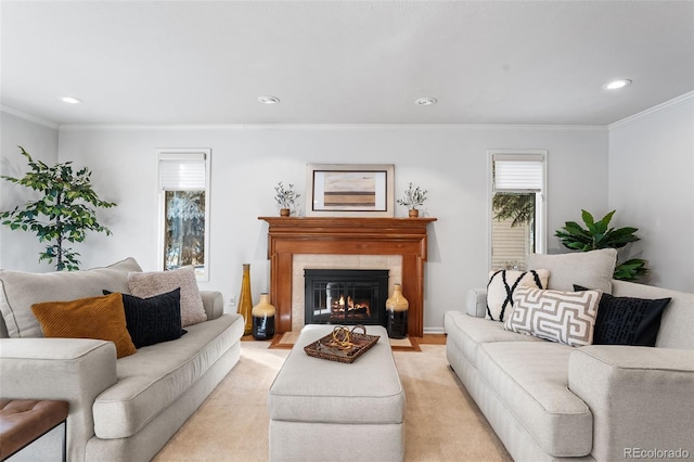 living room featuring recessed lighting, a tile fireplace, light colored carpet, and crown molding