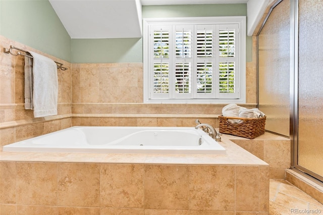 bathroom with lofted ceiling, a shower stall, and a bath