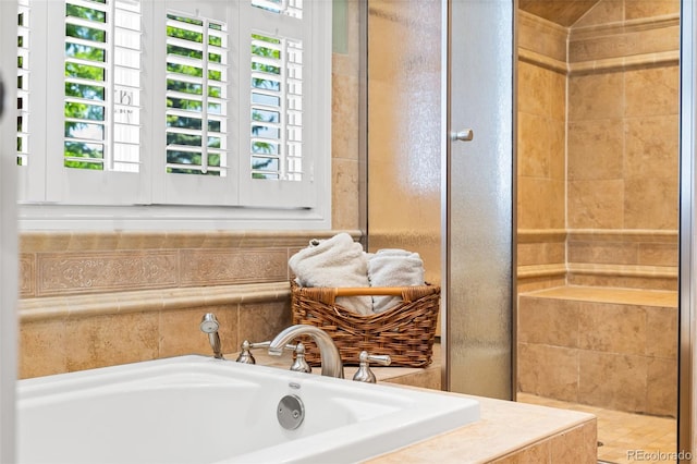 full bathroom with tiled shower and a garden tub