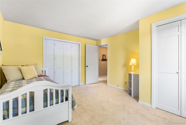 bedroom featuring baseboards and light colored carpet