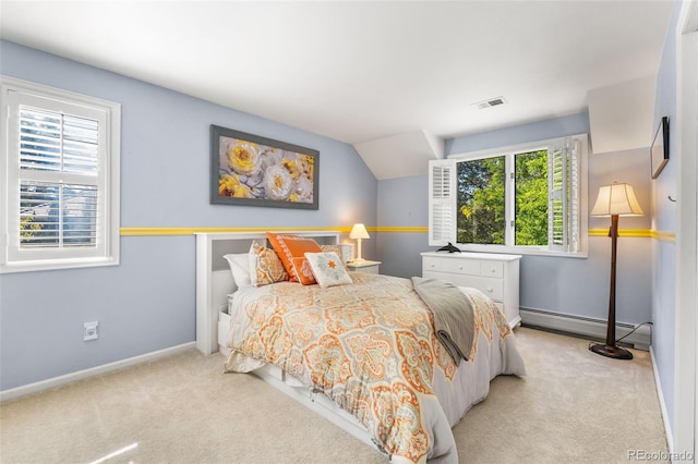 bedroom with baseboards, baseboard heating, visible vents, and light colored carpet