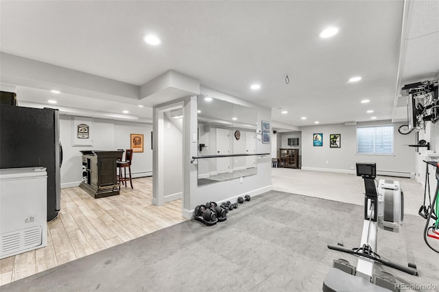 workout area with a baseboard heating unit, a dry bar, baseboards, and recessed lighting