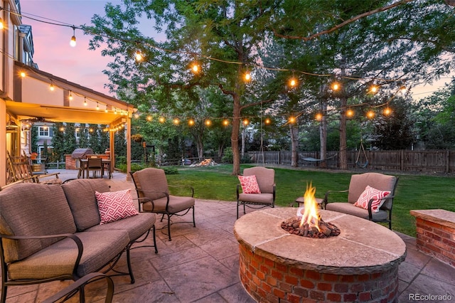 view of patio featuring an outdoor fire pit and a fenced backyard