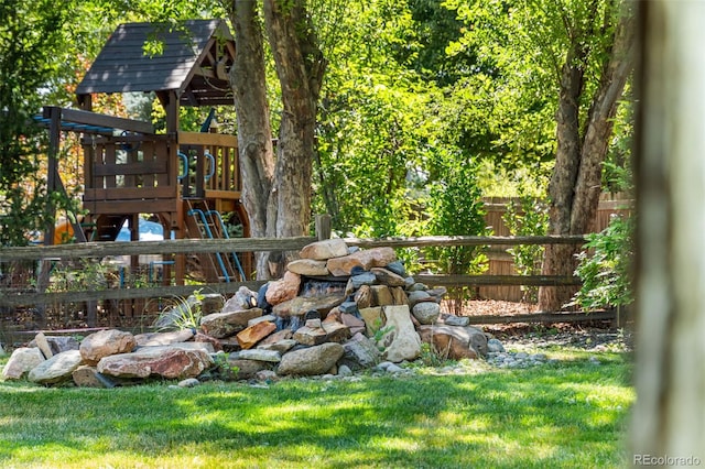 view of yard featuring a playground and fence