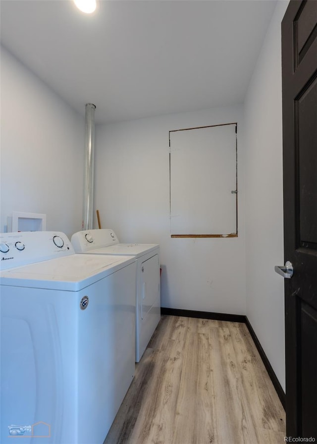 548 Coughlin Meadows Rd, Boulder, CO 80302 - laundry room featuring washing machine and dryer and light wood-style flooring