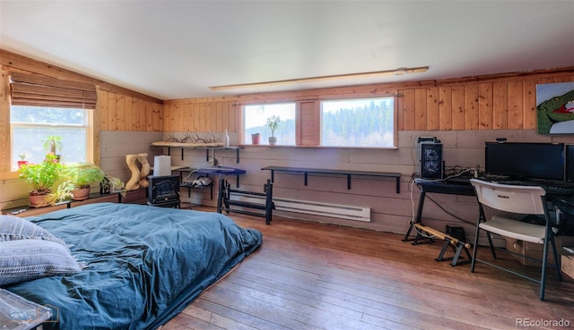 548 Coughlin Meadows Rd, Boulder, CO 80302 - bedroom featuring multiple windows, light wood-style flooring, a baseboard heating unit, wooden walls, and vaulted ceiling