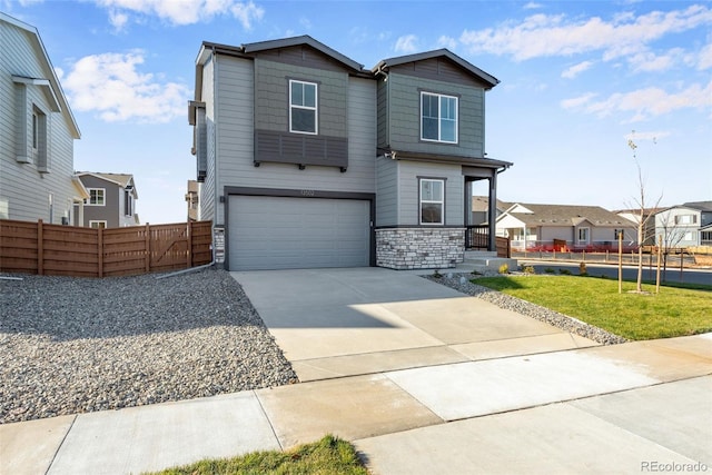13502 E 100th Ave, Commerce City, CO 80022 - view of front of home featuring a garage, stone siding, driveway, and a residential view