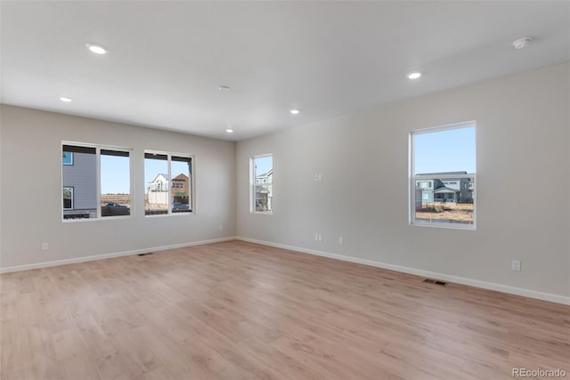 empty room with light hardwood / wood-style flooring