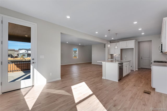 kitchen featuring a kitchen island with sink, light wood-type flooring, white cabinetry, and dishwasher