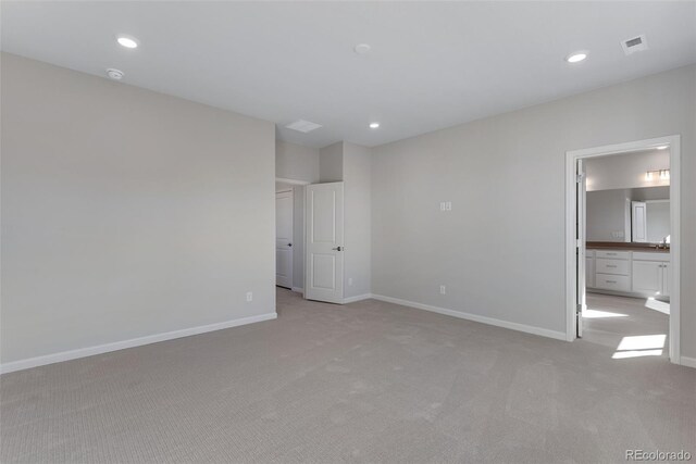13502 E 100th Ave, Commerce City, CO 80022 - unfurnished bedroom featuring light carpet, baseboards, recessed lighting, and ensuite bath