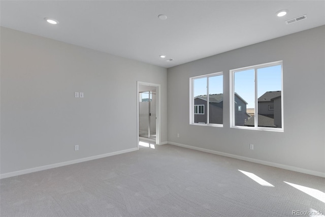 unfurnished room with light colored carpet