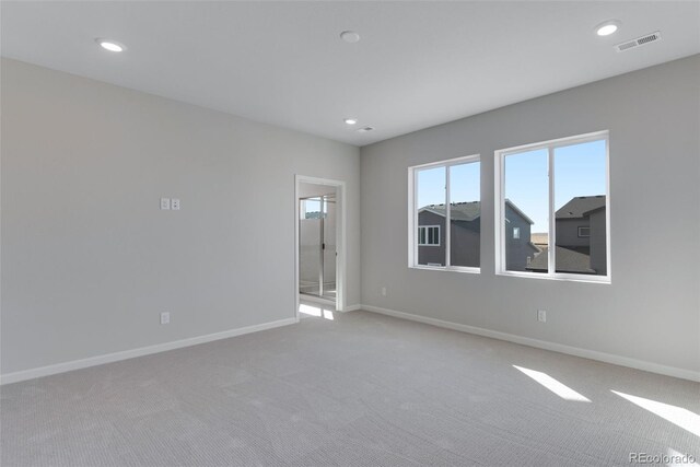 13502 E 100th Ave, Commerce City, CO 80022 - spare room featuring light colored carpet, baseboards, and recessed lighting