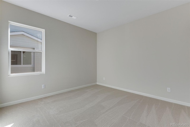 empty room with vaulted ceiling and light carpet