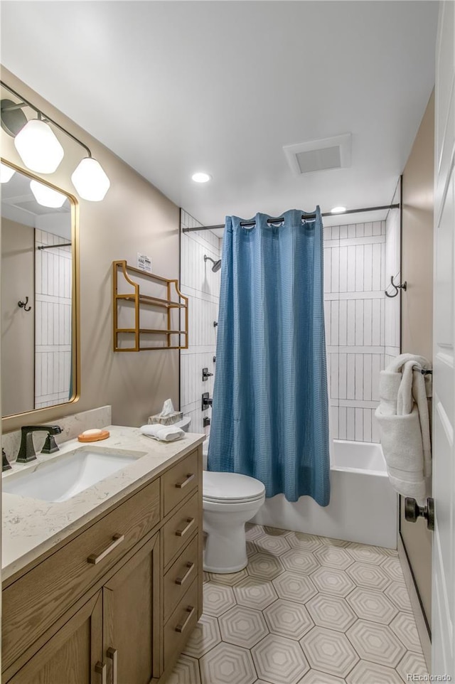 full bathroom featuring vanity, tile patterned floors, toilet, and shower / bath combo with shower curtain