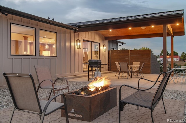 patio terrace at dusk featuring a fire pit