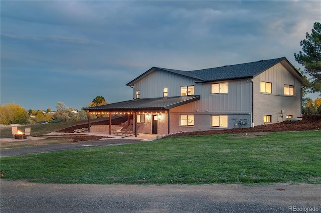 view of front of house featuring a yard and a patio