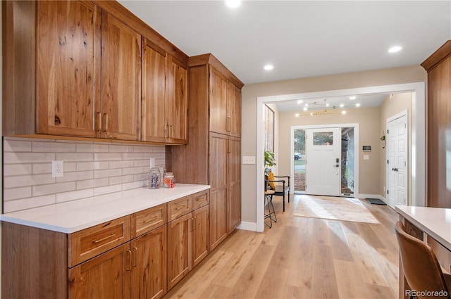 kitchen featuring tasteful backsplash and light hardwood / wood-style floors