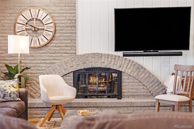 interior space featuring brick wall and a brick fireplace