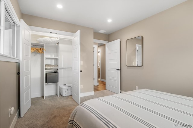 bedroom featuring light colored carpet and a closet