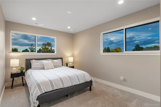 bedroom featuring light colored carpet