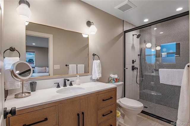 bathroom with vanity, toilet, tile patterned floors, and a shower with shower door