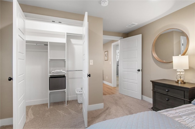 bedroom featuring light colored carpet