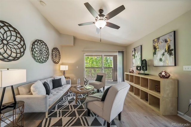 9911 E Idaho Cir Unit 202, Denver, CO 80247 - living area featuring vaulted ceiling, wood finished floors, and ceiling fan