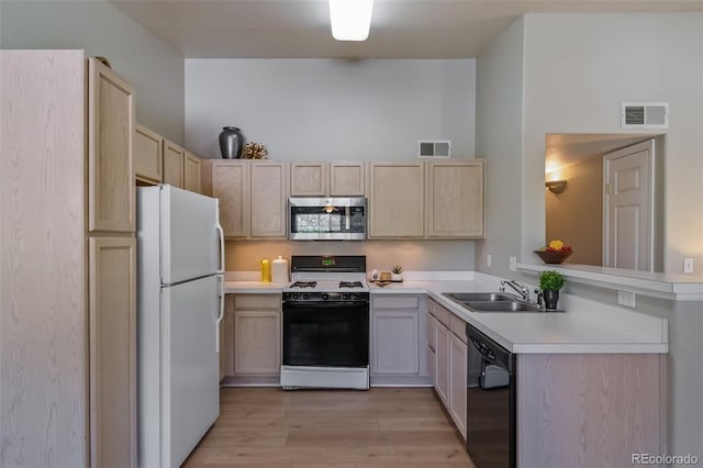 9911 E Idaho Cir Unit 202, Denver, CO 80247 - kitchen with stainless steel microwave, freestanding refrigerator, gas range, black dishwasher, and a sink