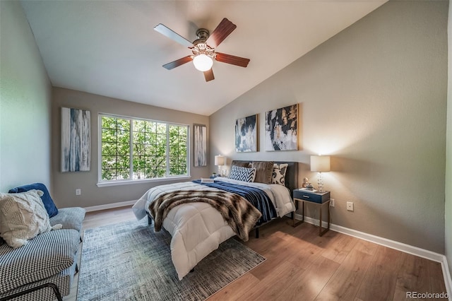 9911 E Idaho Cir Unit 202, Denver, CO 80247 - bedroom featuring baseboards, vaulted ceiling, wood finished floors, and a ceiling fan
