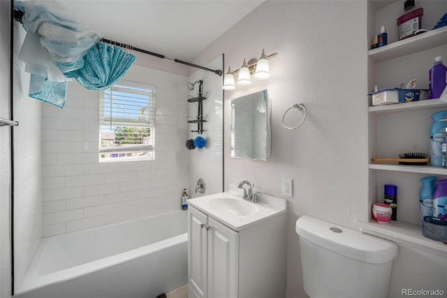 full bathroom with tiled shower / bath combo, toilet, and vanity