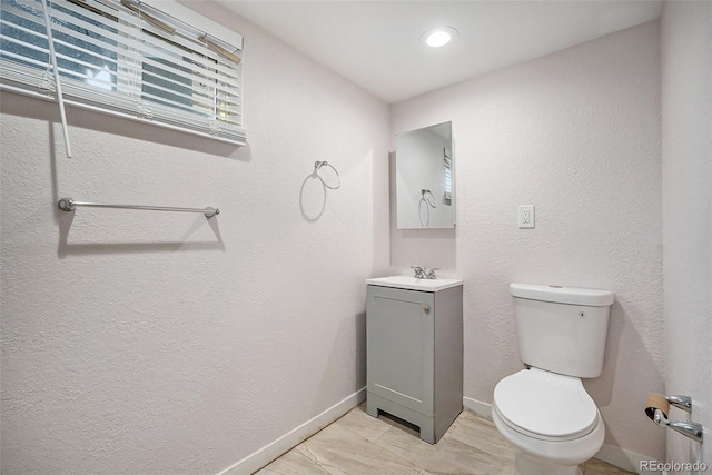 bathroom featuring toilet, vanity, and tile patterned floors