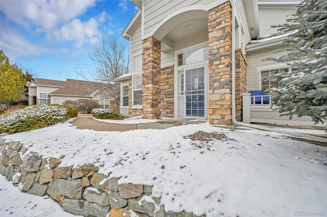 view of snow covered property entrance