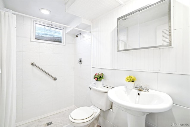 bathroom featuring tile patterned flooring, toilet, and walk in shower