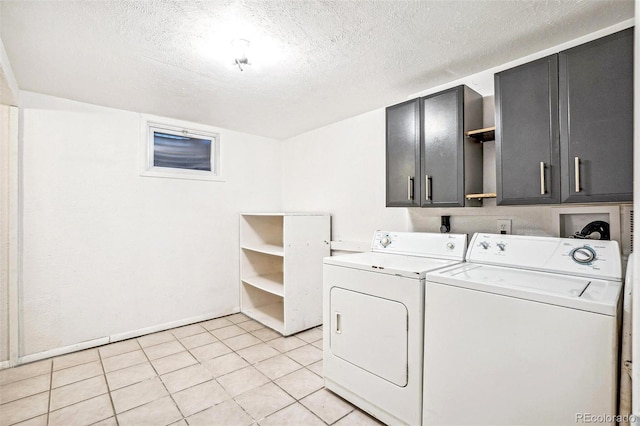 laundry area with light tile patterned flooring, cabinets, separate washer and dryer, and a textured ceiling