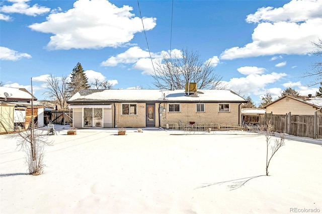 view of snow covered back of property