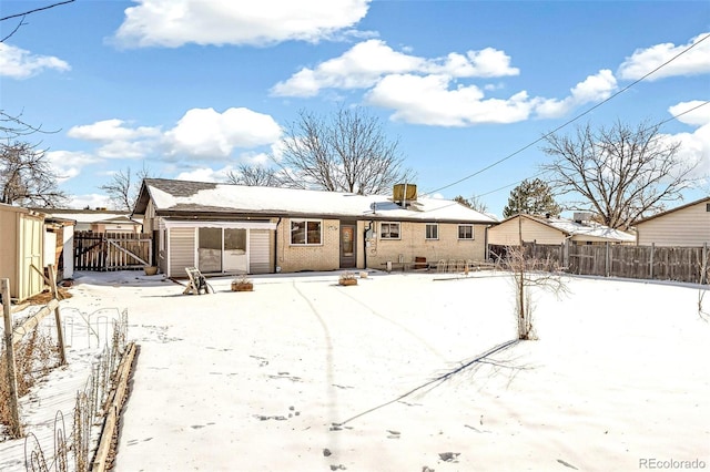 view of snow covered rear of property