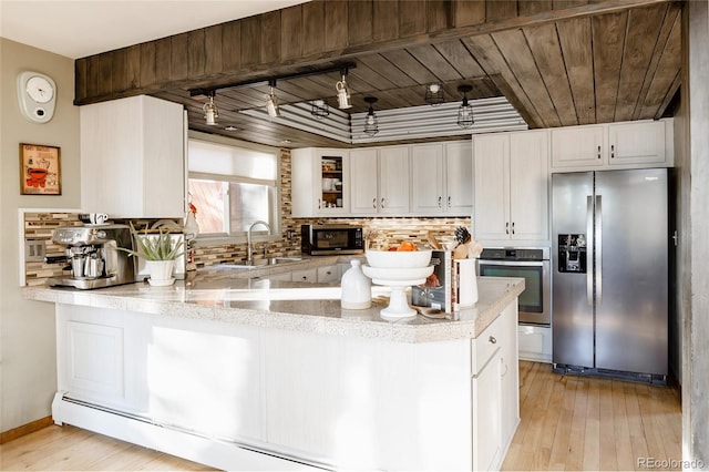 kitchen with sink, appliances with stainless steel finishes, white cabinetry, decorative backsplash, and wooden ceiling