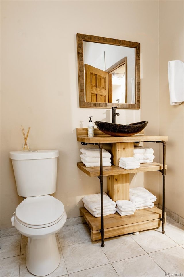 bathroom with tile patterned flooring, sink, and toilet