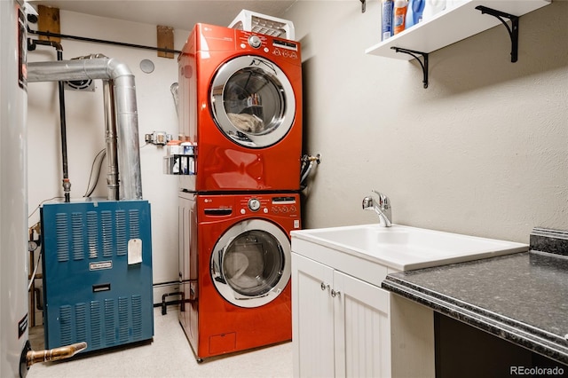 laundry area featuring sink, cabinets, and stacked washing maching and dryer