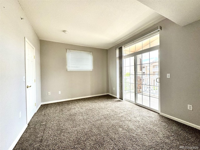 7440 S Blackhawk St Unit 208, Englewood, CO 80112 - spare room featuring carpet and baseboards