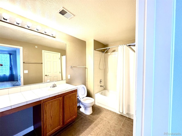 7440 S Blackhawk St Unit 208, Englewood, CO 80112 - bathroom featuring vanity, toilet, shower / bath combo with shower curtain, and a textured ceiling