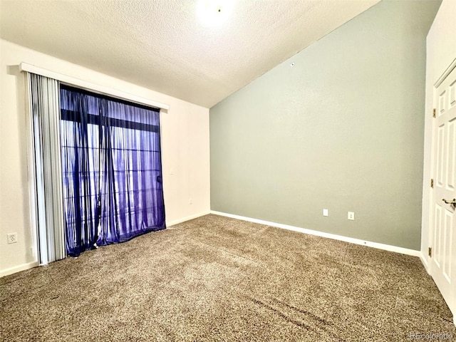 7440 S Blackhawk St Unit 208, Englewood, CO 80112 - carpeted empty room featuring lofted ceiling, a textured ceiling, and baseboards