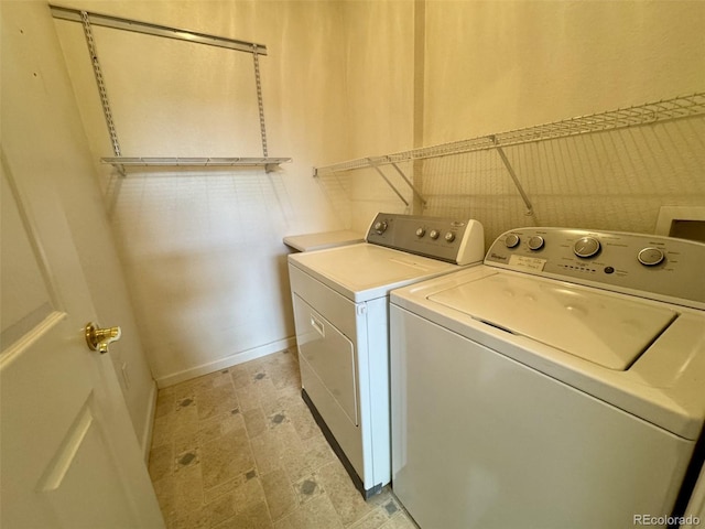 7440 S Blackhawk St Unit 208, Englewood, CO 80112 - laundry area featuring independent washer and dryer and baseboards