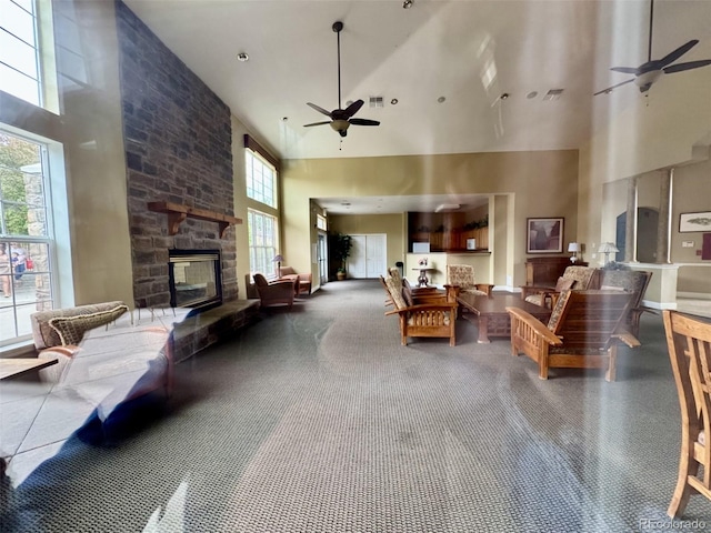 7440 S Blackhawk St Unit 208, Englewood, CO 80112 - living area with a high ceiling, a ceiling fan, and a fireplace