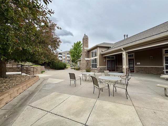 7440 S Blackhawk St Unit 208, Englewood, CO 80112 - view of patio / terrace featuring outdoor dining area and french doors