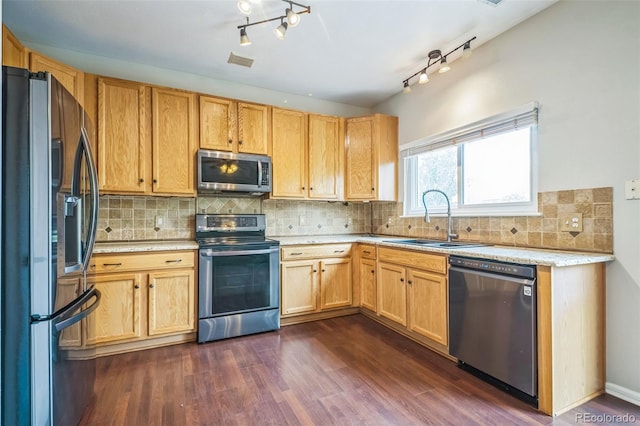2446 S Gibralter Way, Aurora, CO 80013 - kitchen with stainless steel appliances, dark wood-style flooring, tasteful backsplash, and rail lighting