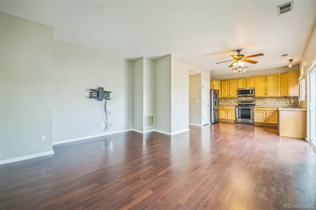 2446 S Gibralter Way, Aurora, CO 80013 - unfurnished living room featuring a ceiling fan and dark wood-type flooring
