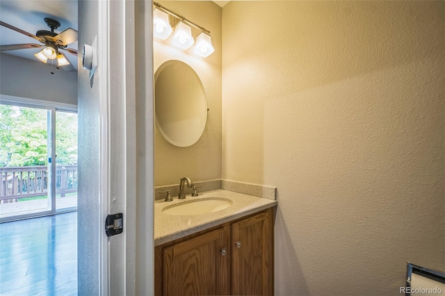 2446 S Gibralter Way, Aurora, CO 80013 - bathroom featuring vanity, a textured wall, and a ceiling fan