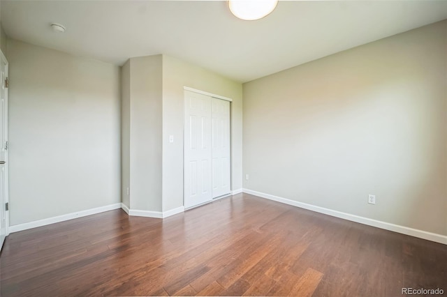 2446 S Gibralter Way, Aurora, CO 80013 - unfurnished bedroom featuring wood finished floors and a closet